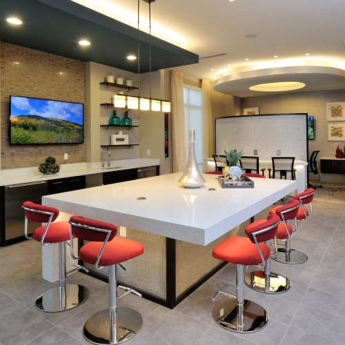 Spacious lounge, TV and nearness to the lobby a room with a table and chairs