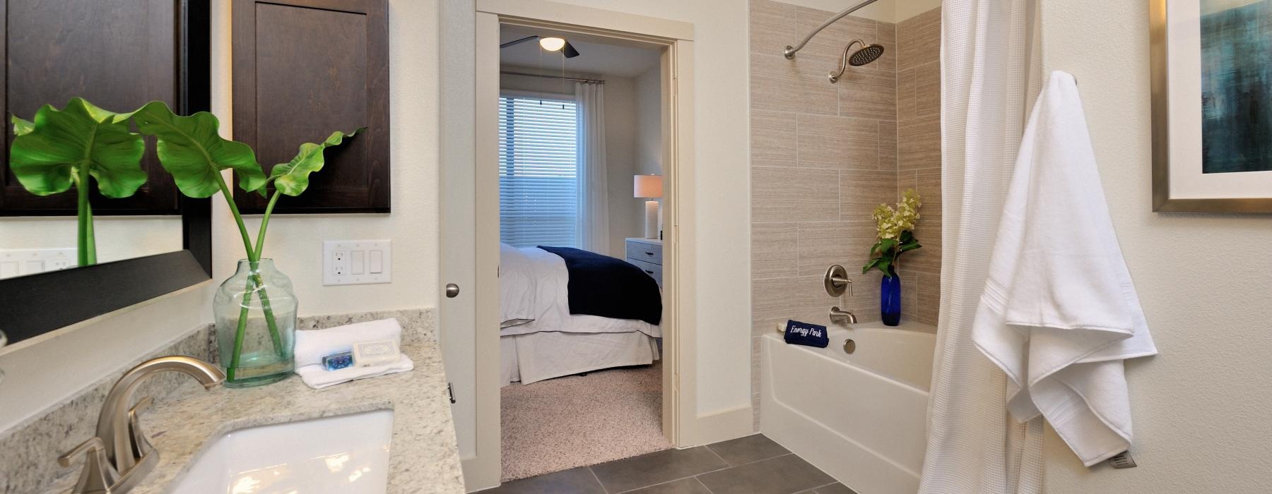 a bathroom with a sink and a bed