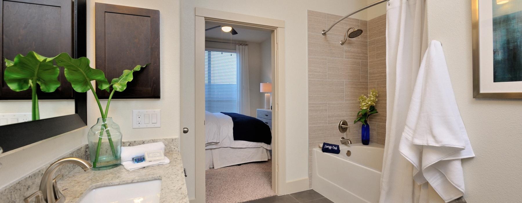 a bathroom with a sink and a bed